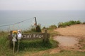Floral tributes at the cliff edge